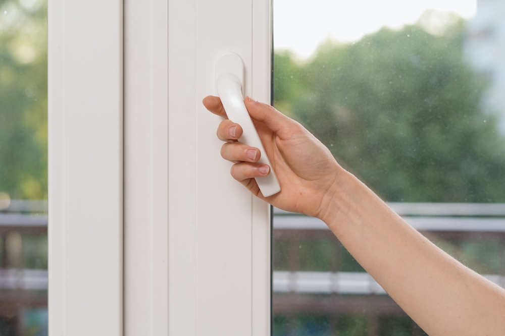 Cropped,View,Of,Woman,Hand,Open,Plastic,Window,In,Living